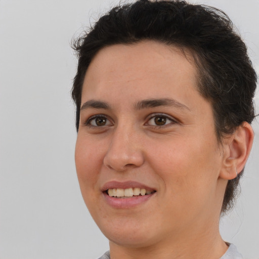 Joyful white young-adult female with short  brown hair and brown eyes