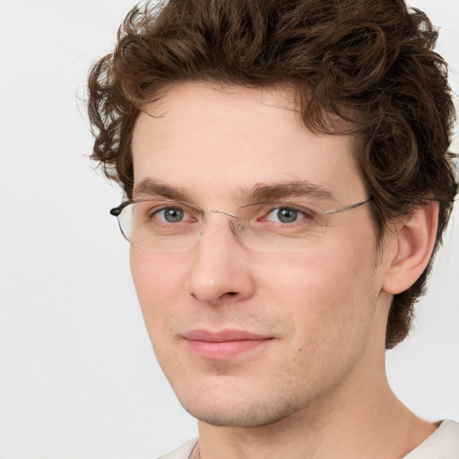 Joyful white young-adult male with short  brown hair and green eyes