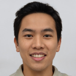 Joyful asian young-adult male with short  black hair and brown eyes