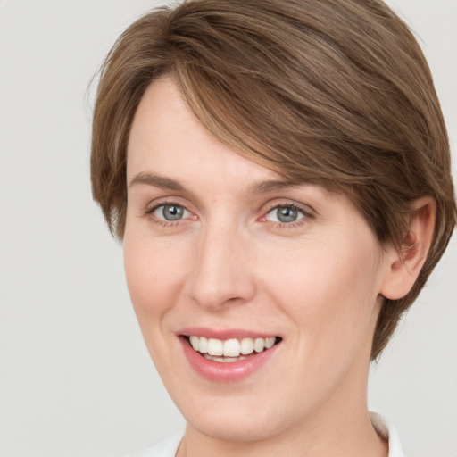 Joyful white young-adult female with medium  brown hair and green eyes