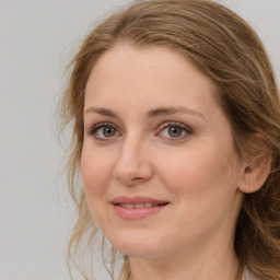 Joyful white adult female with long  brown hair and brown eyes