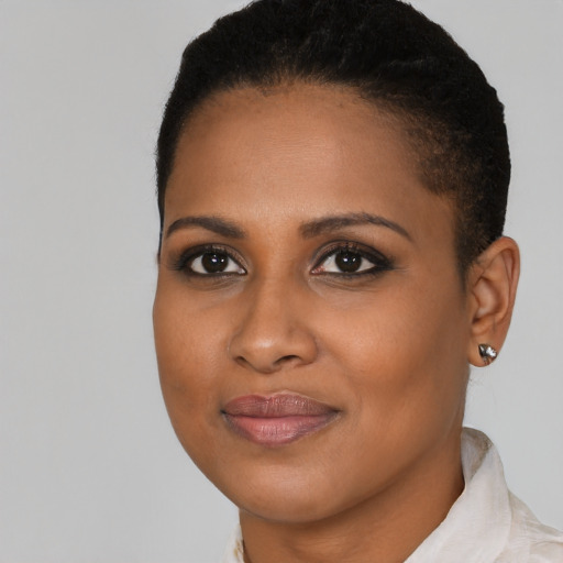Joyful black young-adult female with short  brown hair and brown eyes