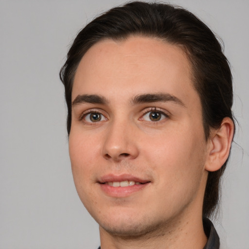 Joyful white young-adult male with medium  brown hair and brown eyes