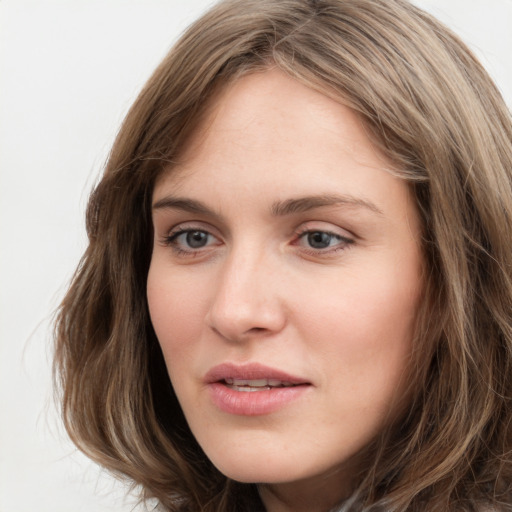 Joyful white young-adult female with long  brown hair and grey eyes