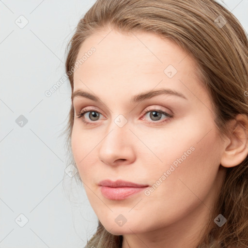 Joyful white young-adult female with long  brown hair and blue eyes