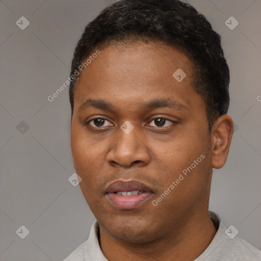 Joyful black young-adult male with short  black hair and brown eyes