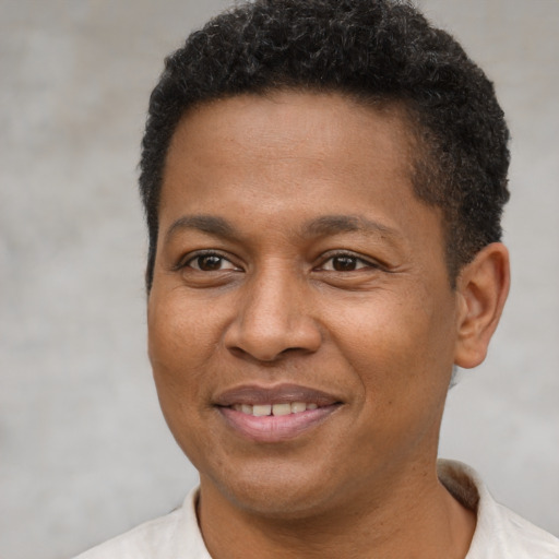 Joyful black adult male with short  brown hair and brown eyes