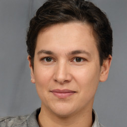 Joyful white adult male with short  brown hair and grey eyes