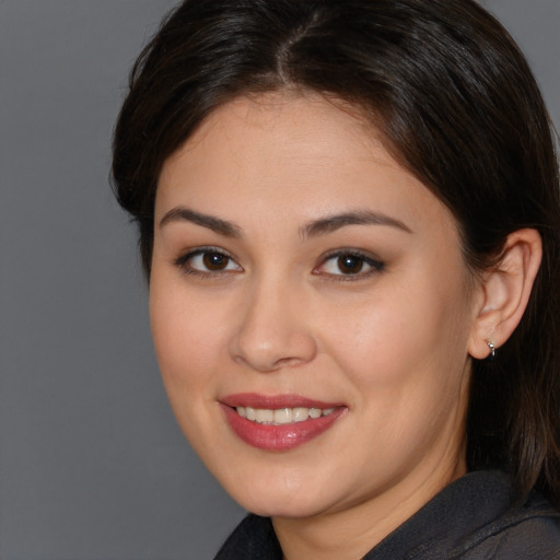 Joyful white young-adult female with medium  brown hair and brown eyes