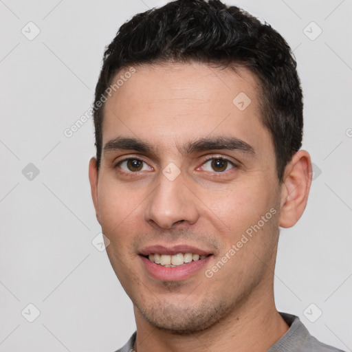 Joyful white young-adult male with short  black hair and brown eyes