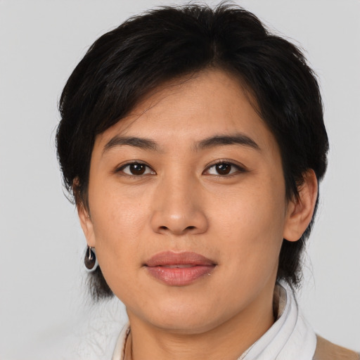 Joyful asian young-adult female with medium  brown hair and brown eyes