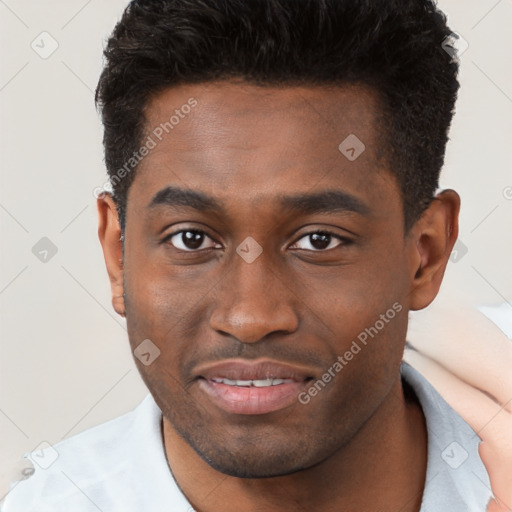 Joyful black young-adult male with short  brown hair and brown eyes