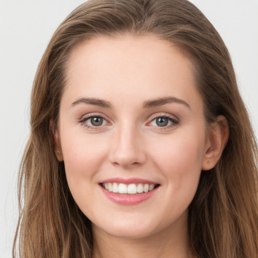 Joyful white young-adult female with long  brown hair and grey eyes