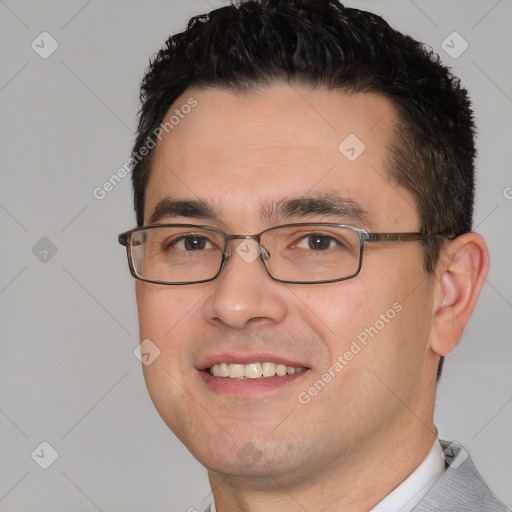 Joyful white young-adult male with short  black hair and brown eyes