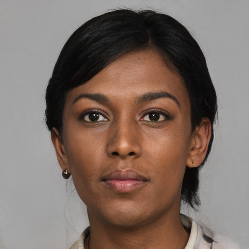 Neutral black young-adult female with medium  black hair and brown eyes
