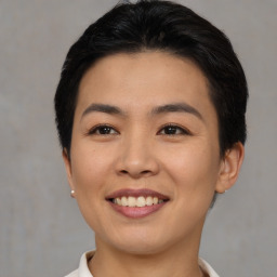 Joyful asian young-adult female with short  black hair and brown eyes