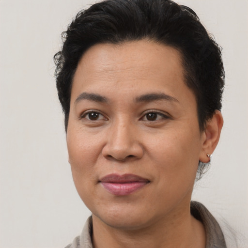 Joyful asian adult female with short  brown hair and brown eyes