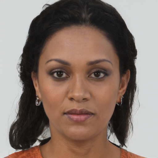 Joyful black young-adult female with medium  brown hair and brown eyes