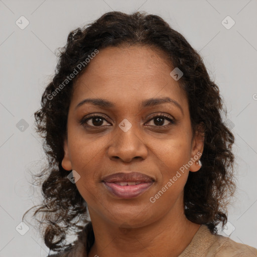 Joyful black adult female with medium  brown hair and brown eyes