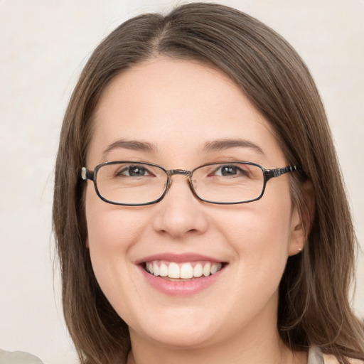 Joyful white young-adult female with medium  brown hair and grey eyes