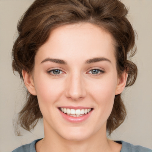 Joyful white young-adult female with medium  brown hair and green eyes