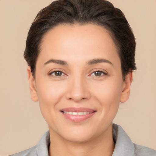 Joyful white young-adult female with short  brown hair and brown eyes