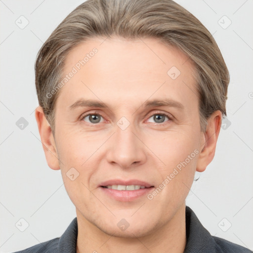 Joyful white adult male with short  brown hair and grey eyes