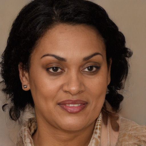 Joyful black adult female with medium  brown hair and brown eyes