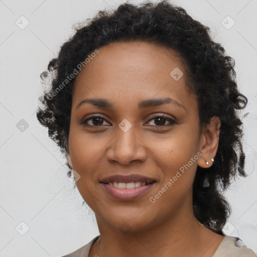 Joyful black young-adult female with long  brown hair and brown eyes