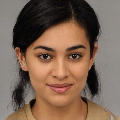 Joyful latino young-adult female with medium  black hair and brown eyes