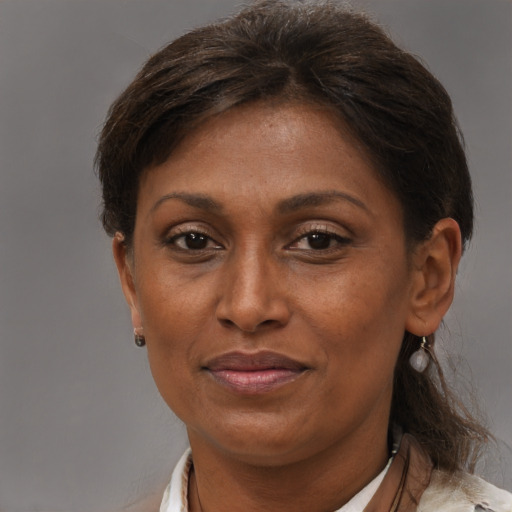 Joyful black adult female with short  brown hair and brown eyes