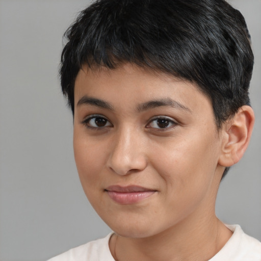Joyful latino young-adult female with short  black hair and brown eyes
