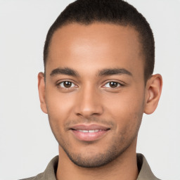 Joyful latino young-adult male with short  brown hair and brown eyes