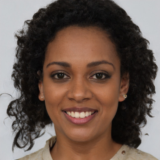 Joyful black young-adult female with medium  brown hair and brown eyes