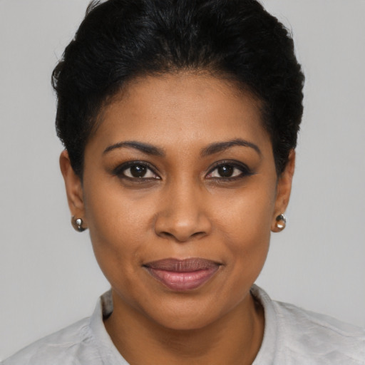 Joyful black young-adult female with short  brown hair and brown eyes