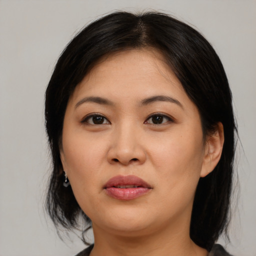 Joyful asian young-adult female with medium  black hair and brown eyes