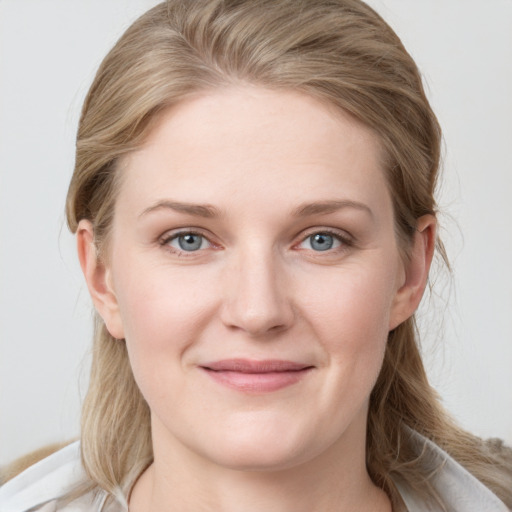 Joyful white young-adult female with medium  brown hair and blue eyes