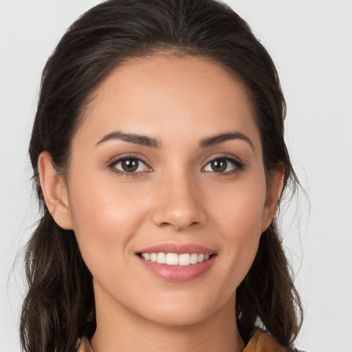 Joyful white young-adult female with long  brown hair and brown eyes