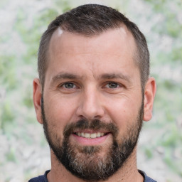 Joyful white adult male with short  brown hair and brown eyes