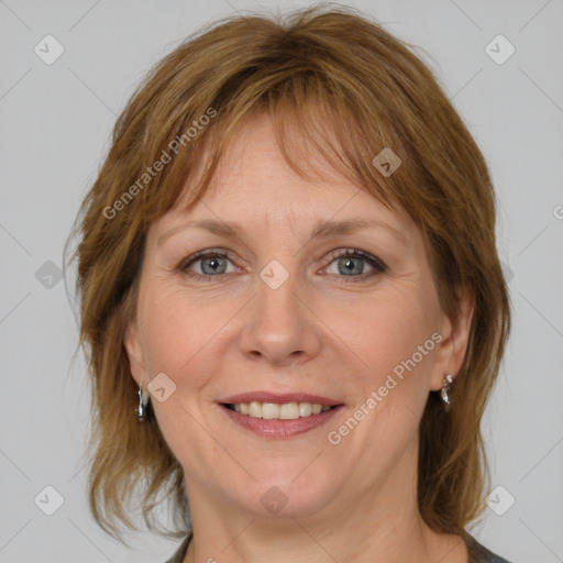 Joyful white adult female with medium  brown hair and blue eyes