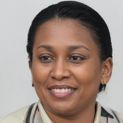 Joyful black young-adult female with short  brown hair and brown eyes