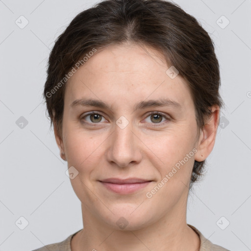 Joyful white young-adult female with short  brown hair and grey eyes