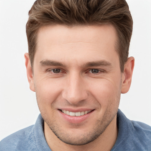 Joyful white young-adult male with short  brown hair and grey eyes