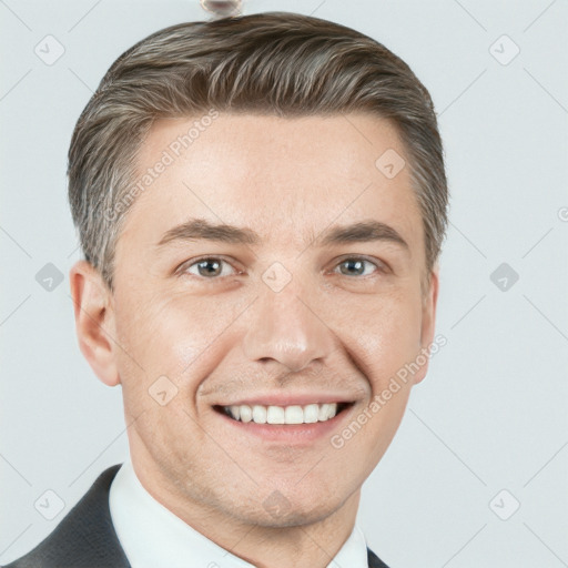 Joyful white adult male with short  brown hair and grey eyes