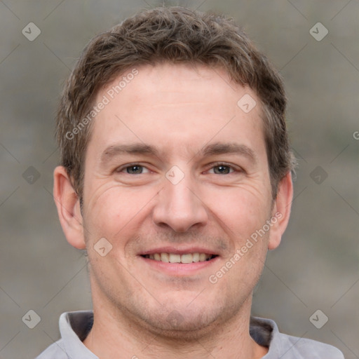 Joyful white adult male with short  brown hair and grey eyes