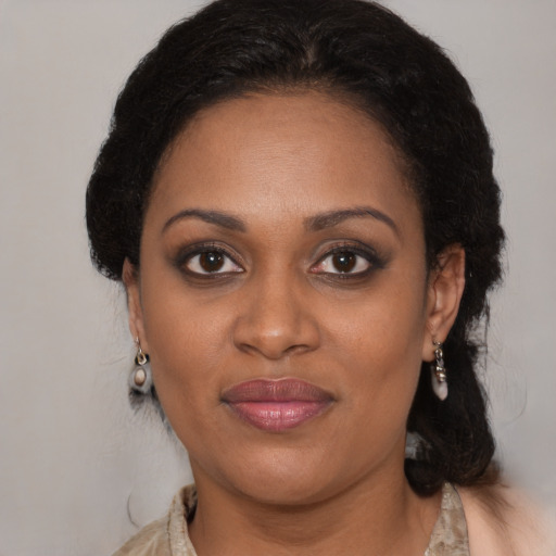 Joyful black adult female with medium  brown hair and brown eyes
