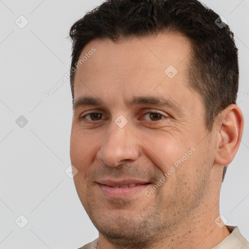 Joyful white adult male with short  brown hair and brown eyes