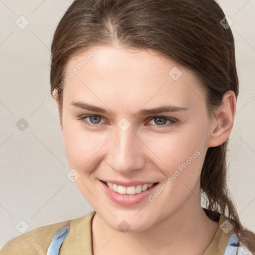 Joyful white young-adult female with medium  brown hair and grey eyes