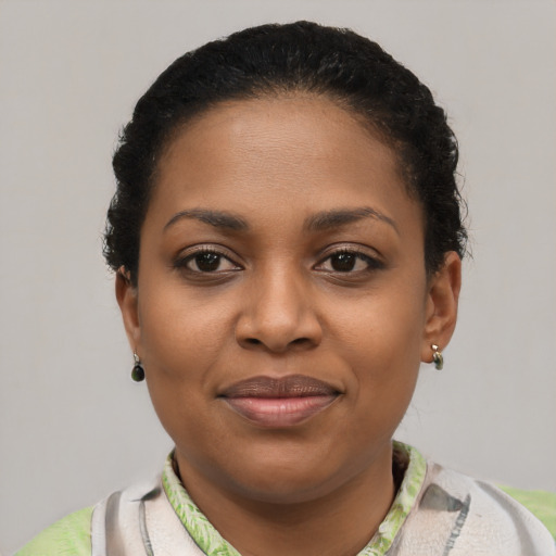 Joyful black young-adult female with short  brown hair and brown eyes