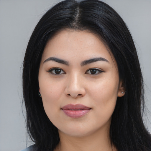 Joyful asian young-adult female with long  black hair and brown eyes
